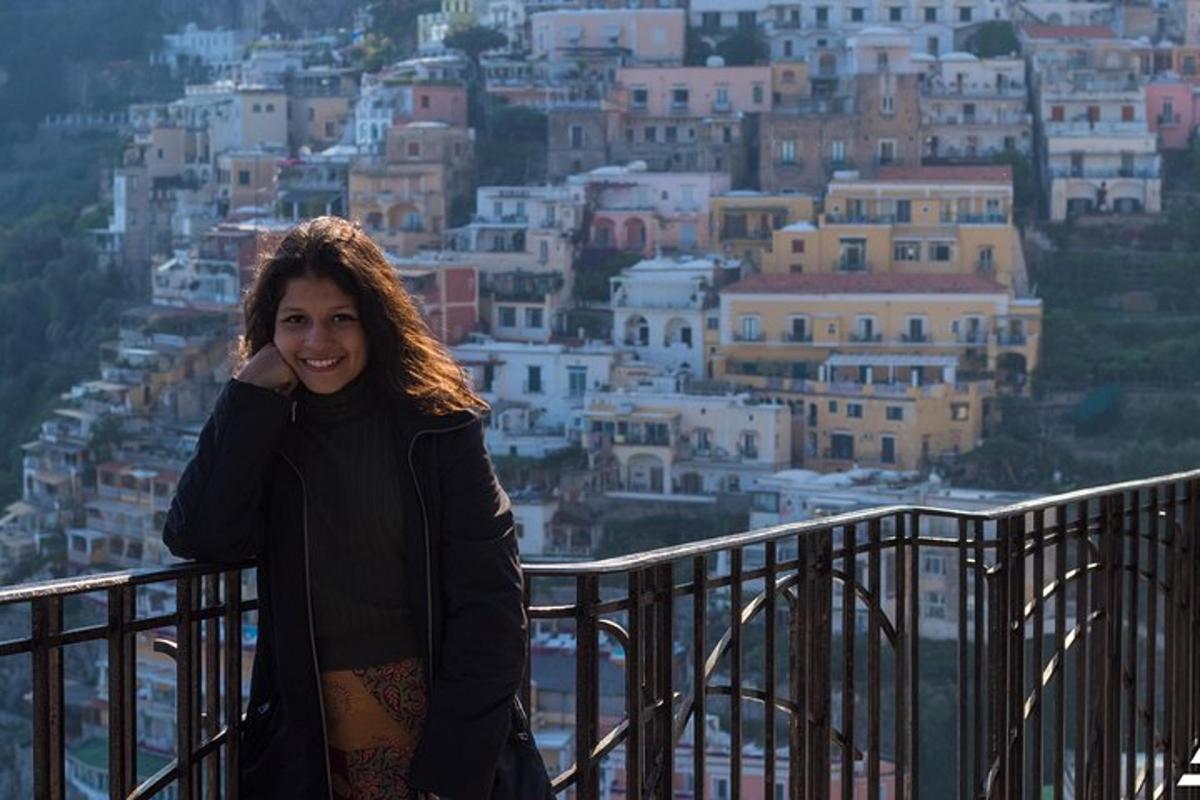 a woman standing on a balcony overlooking a city