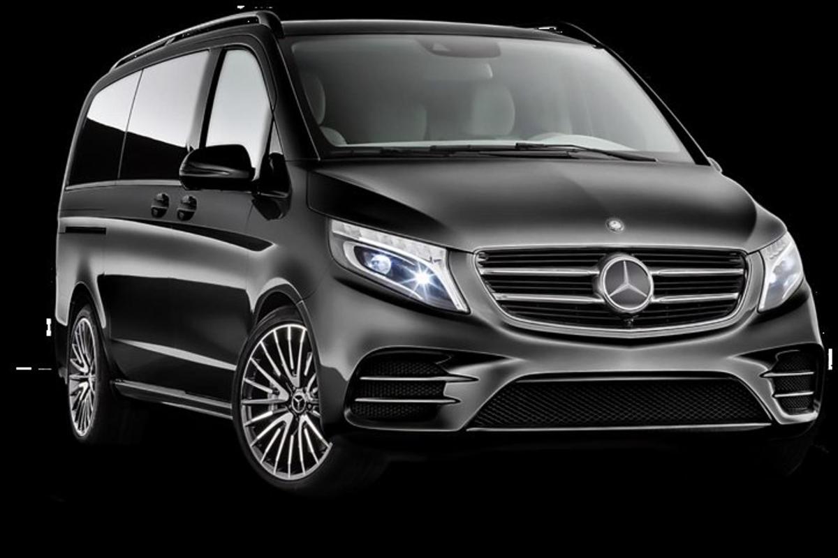 a silver mercedes benz minivan in a black background