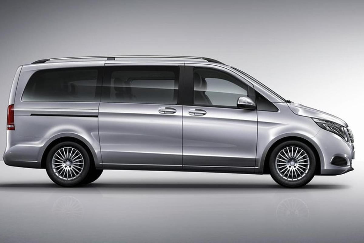 a silver van is parked in a parking lot