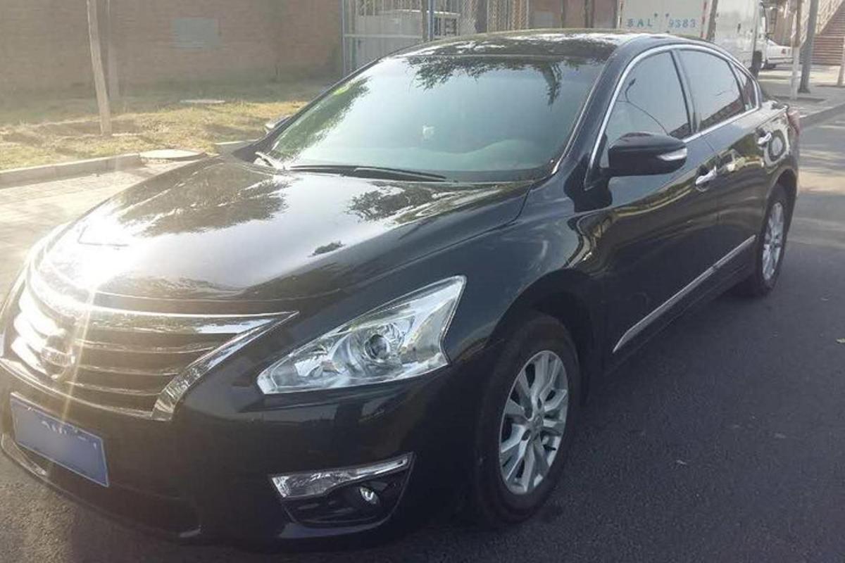 a black car is parked on a street