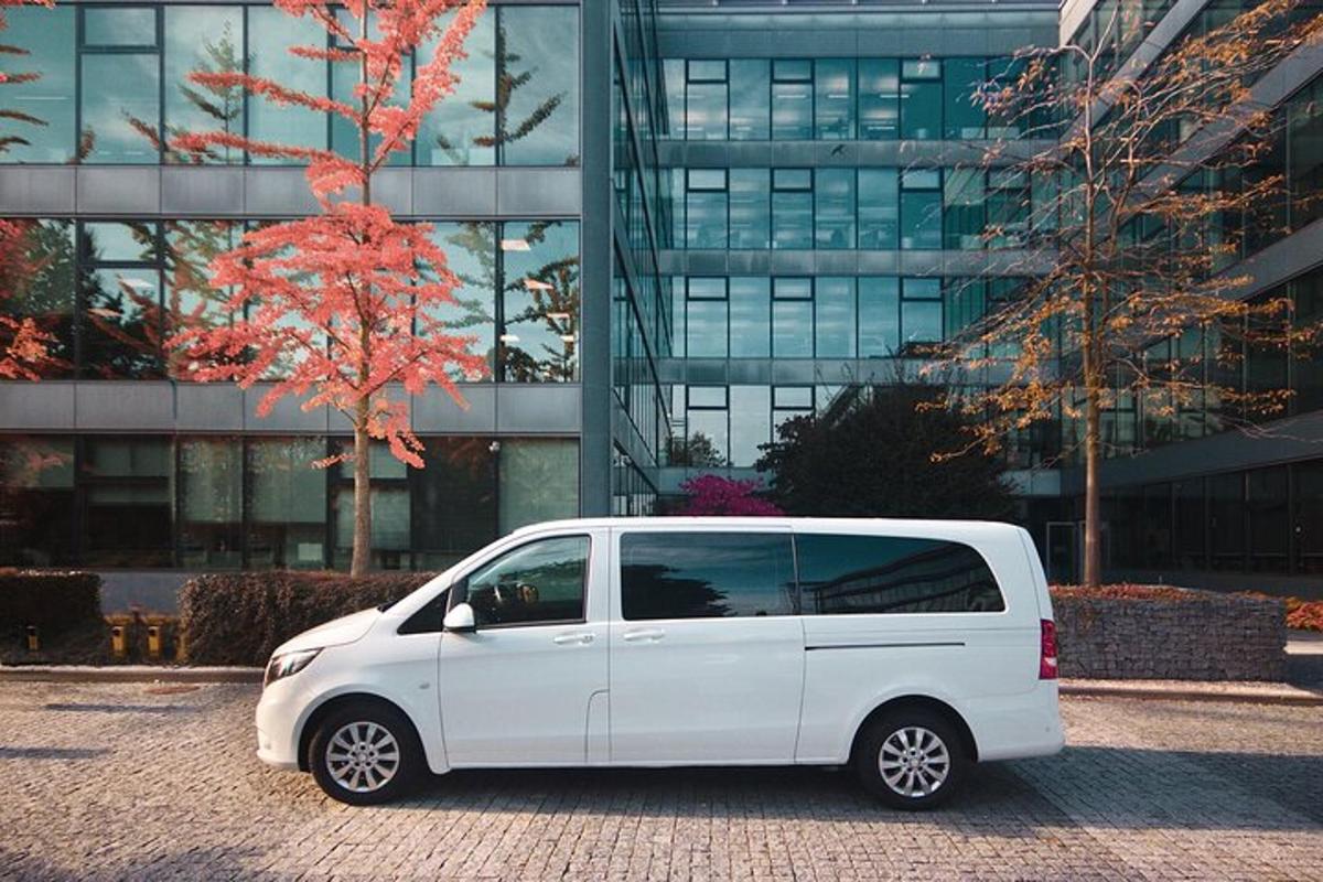 a white van parked in front of a building