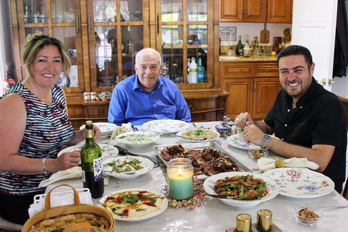 three people sitting at a table with plates of food