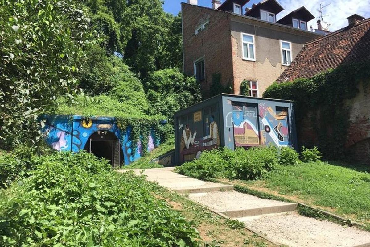 a building with graffiti on it next to a house