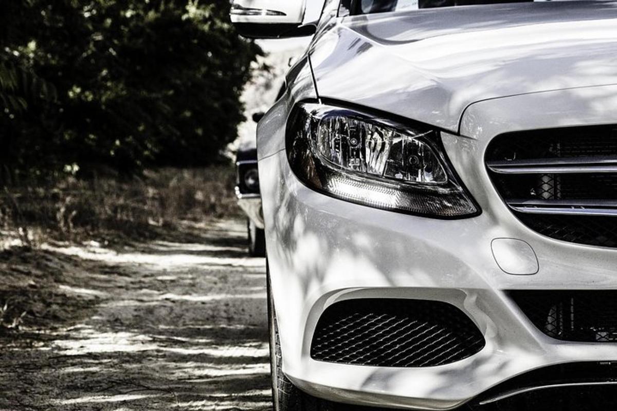 a silver car parked on a dirt road