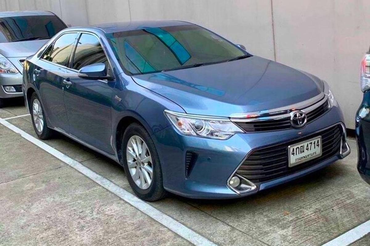 a blue car parked in a parking lot