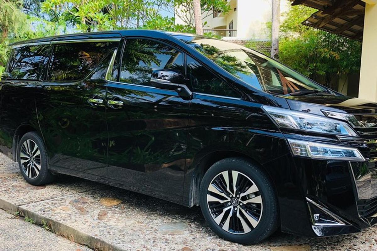 a black car parked on the side of a street
