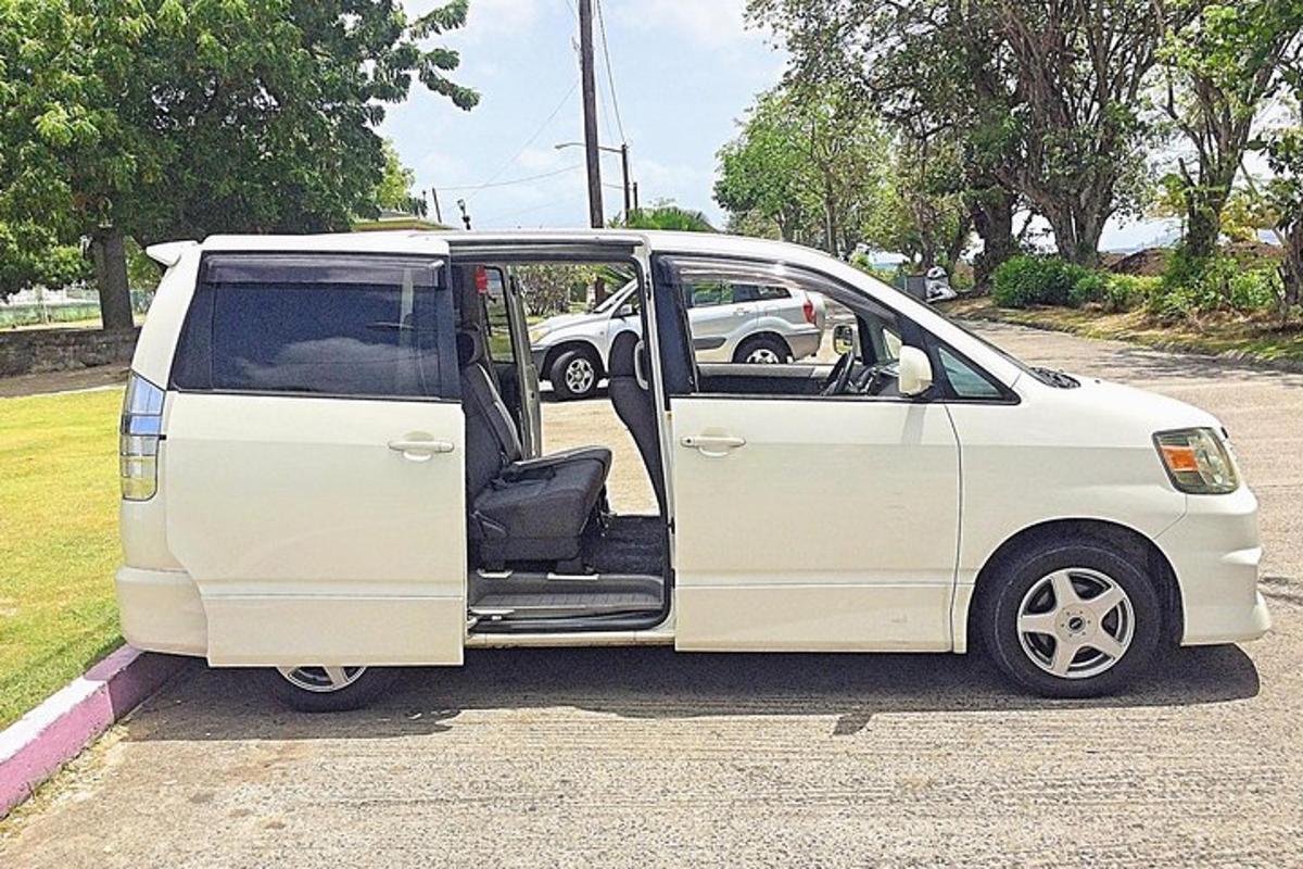 a white van parked in a parking lot with its door open