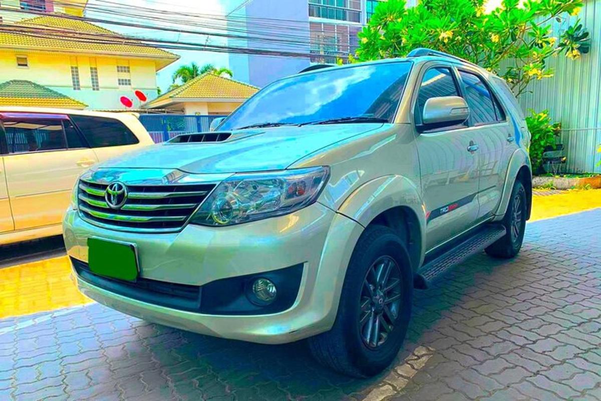 a white suv is parked on a street