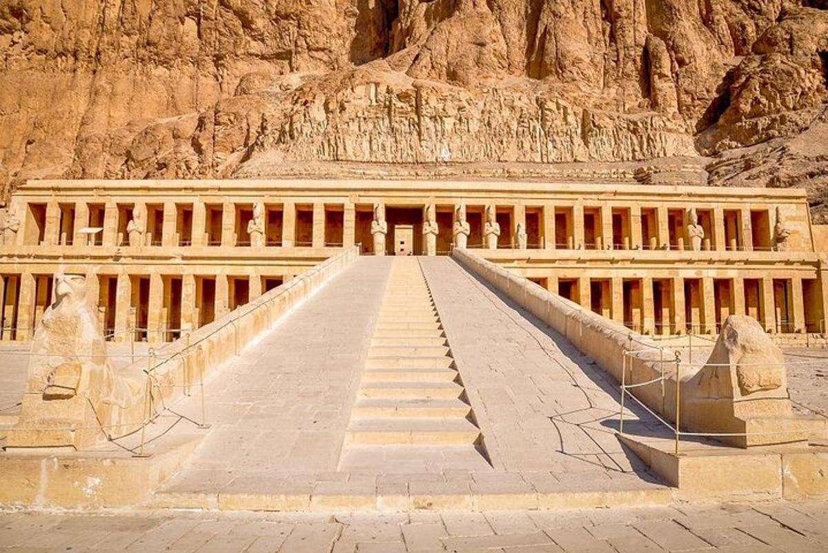 a staircase leading to a building in front of a mountain