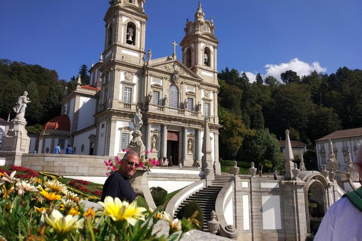 a man standing in front of a building with flowers