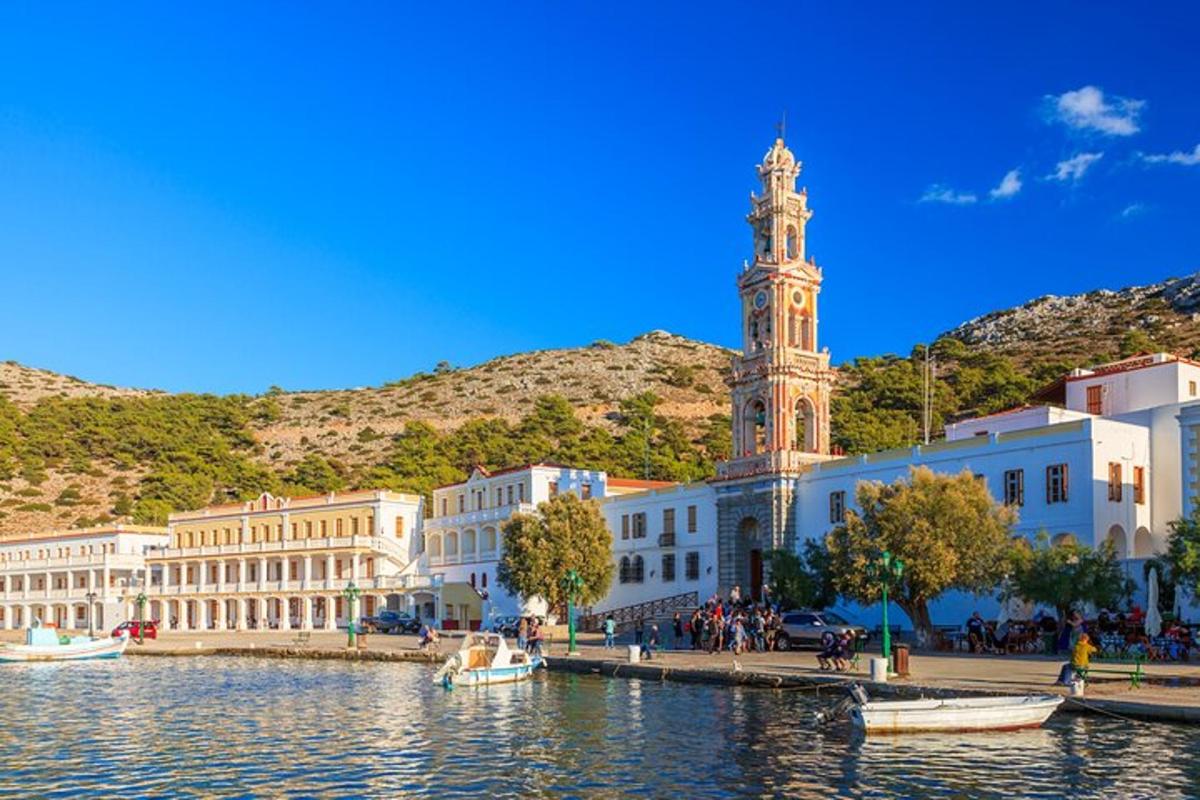 a city with a clock tower next to a body of water