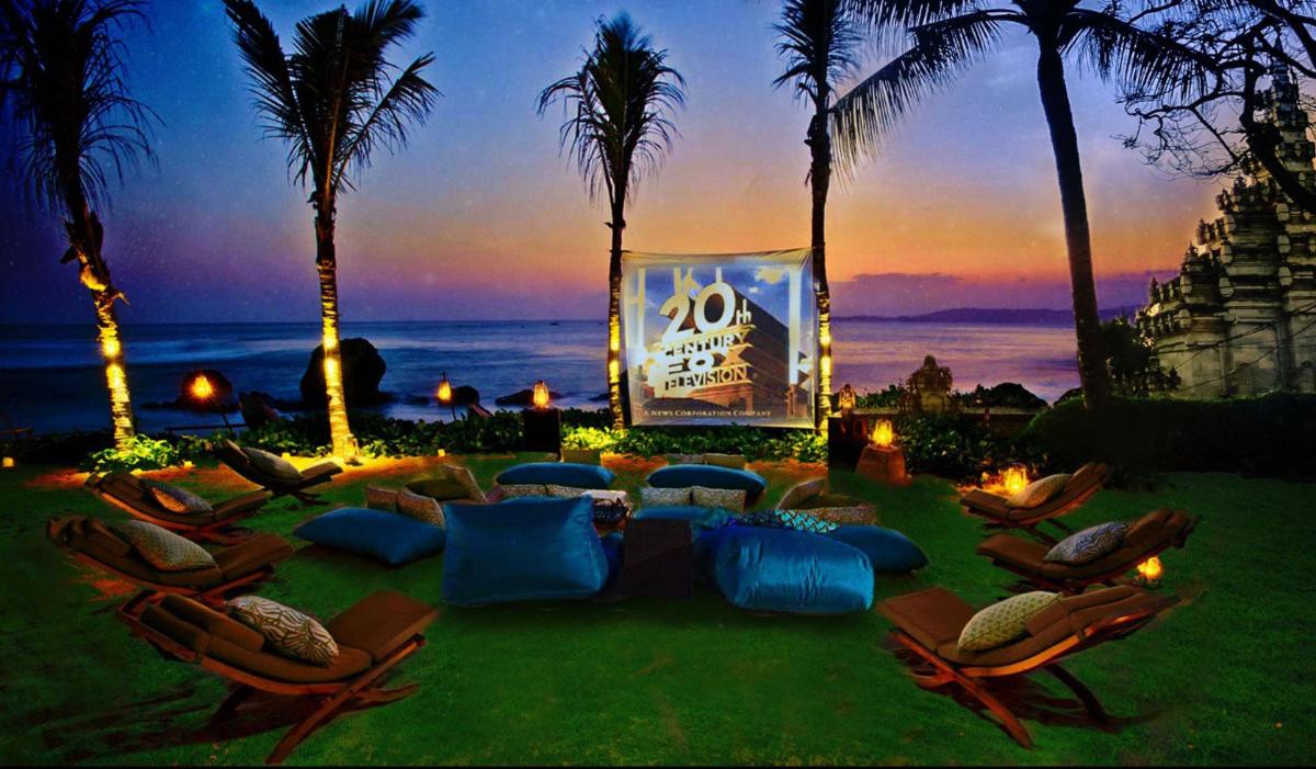 a group of chairs and a stage with the ocean