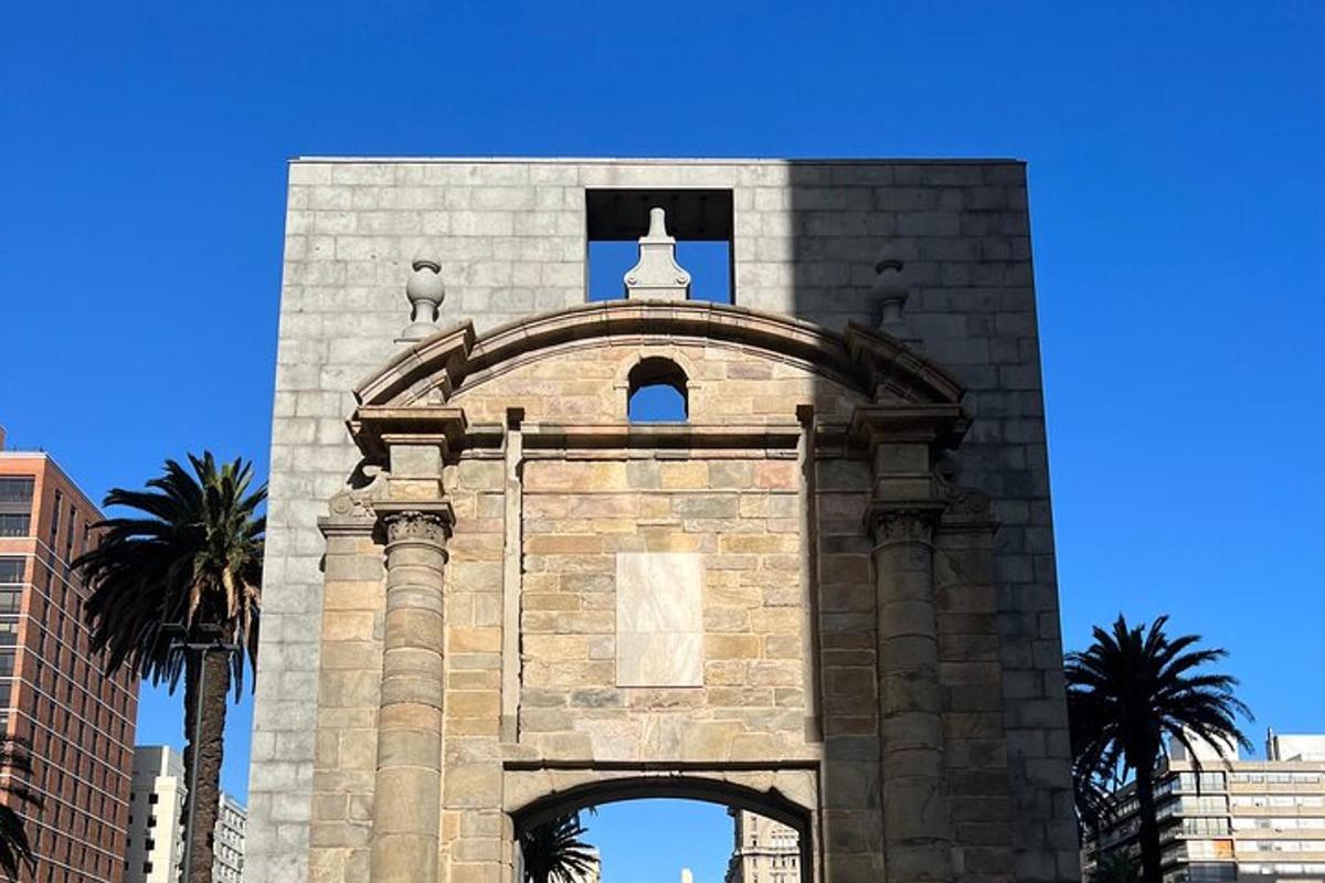 a tall building with an arch in front