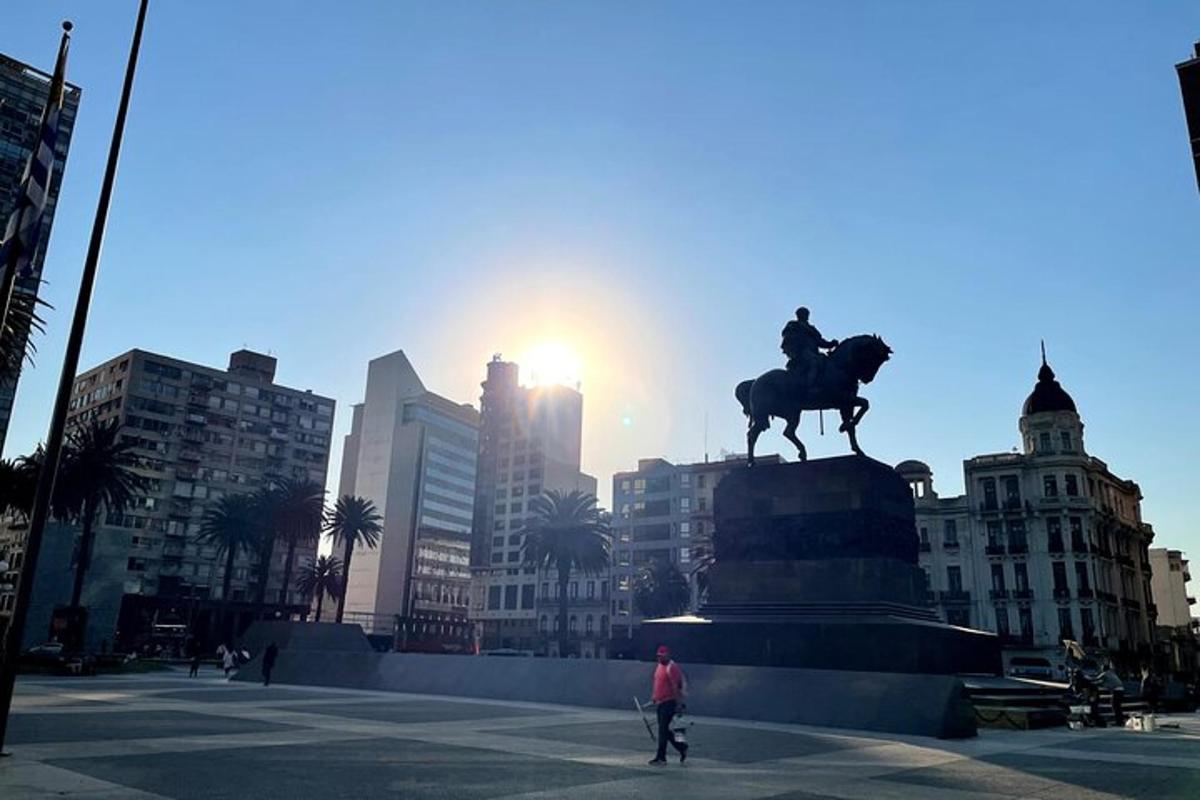 a man standing in front of a statue of a man on a horse