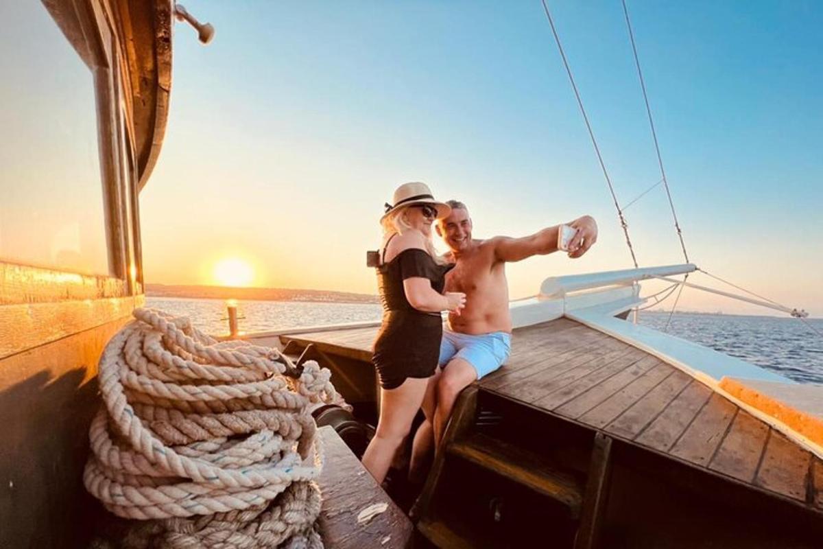 a man and a woman standing on a boat