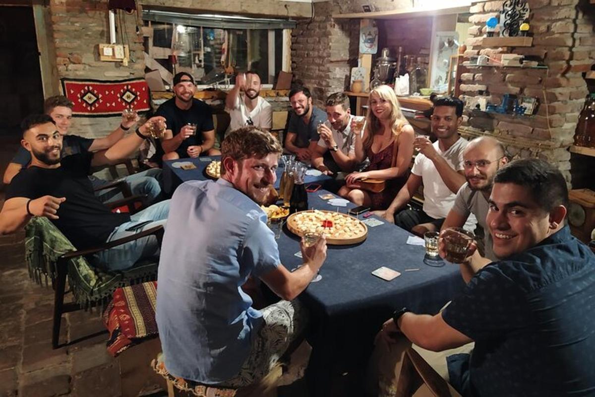 skupina lidí sedících kolem stolu a jedících pizzu