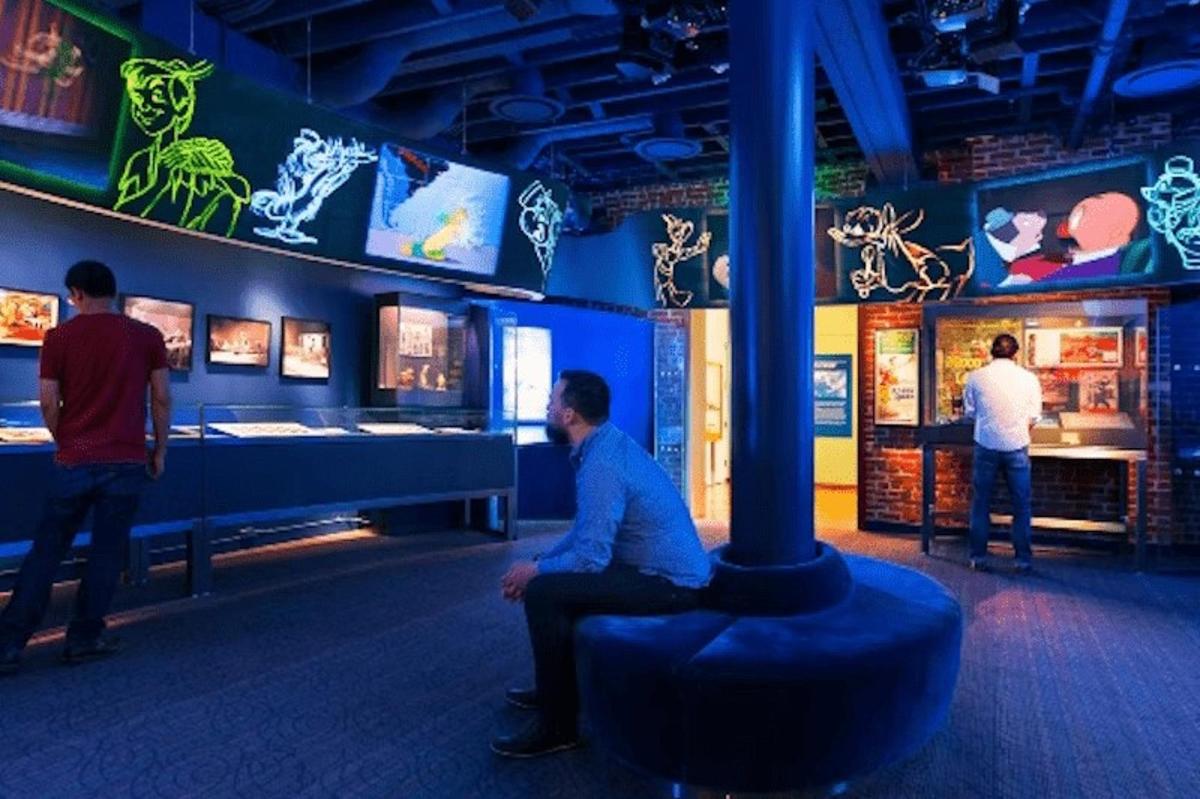 a group of people looking at exhibits in a museum