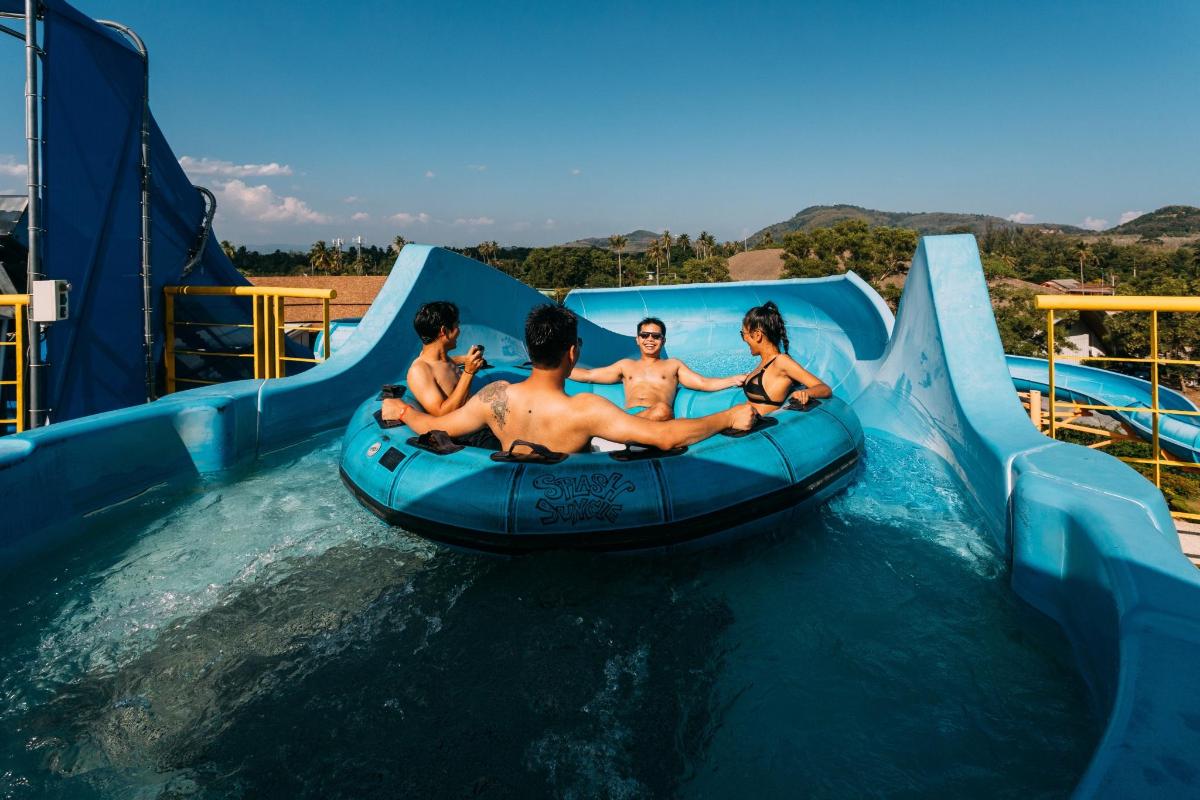 a group of boys riding on a water slide