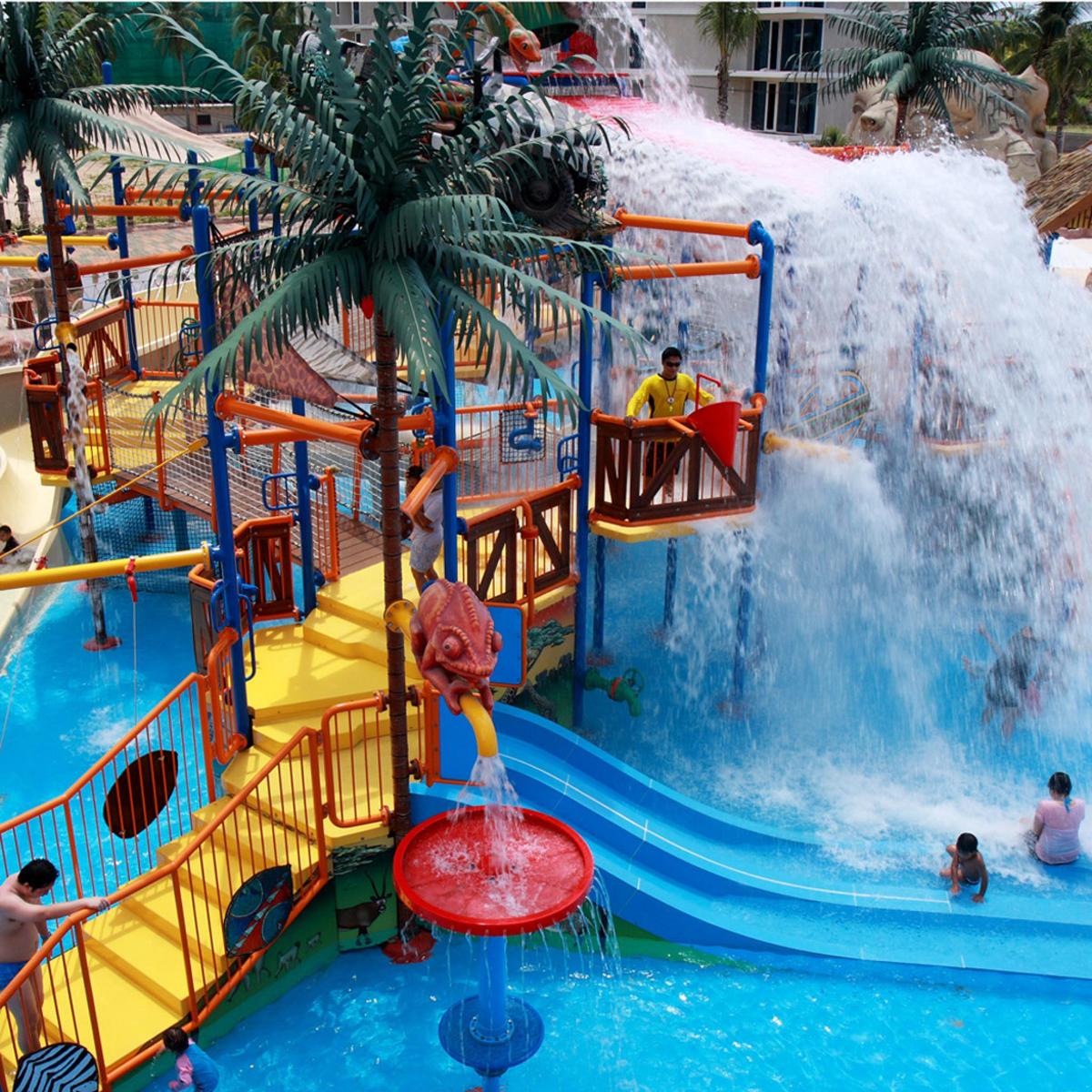 a water slide at a theme park with a girl on a water fall