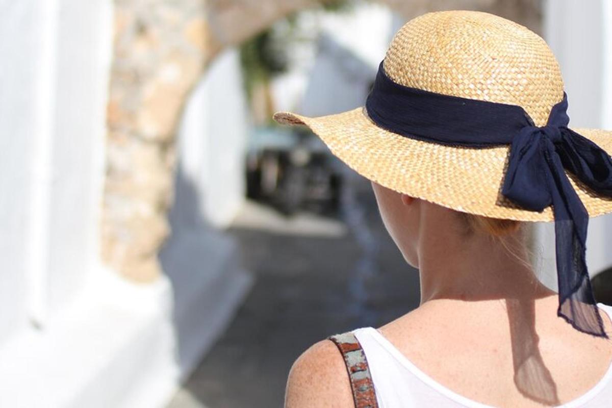 a woman wearing a straw hat with a blue bow