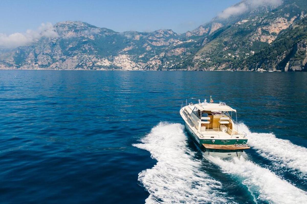 a boat on a large body of water with mountains