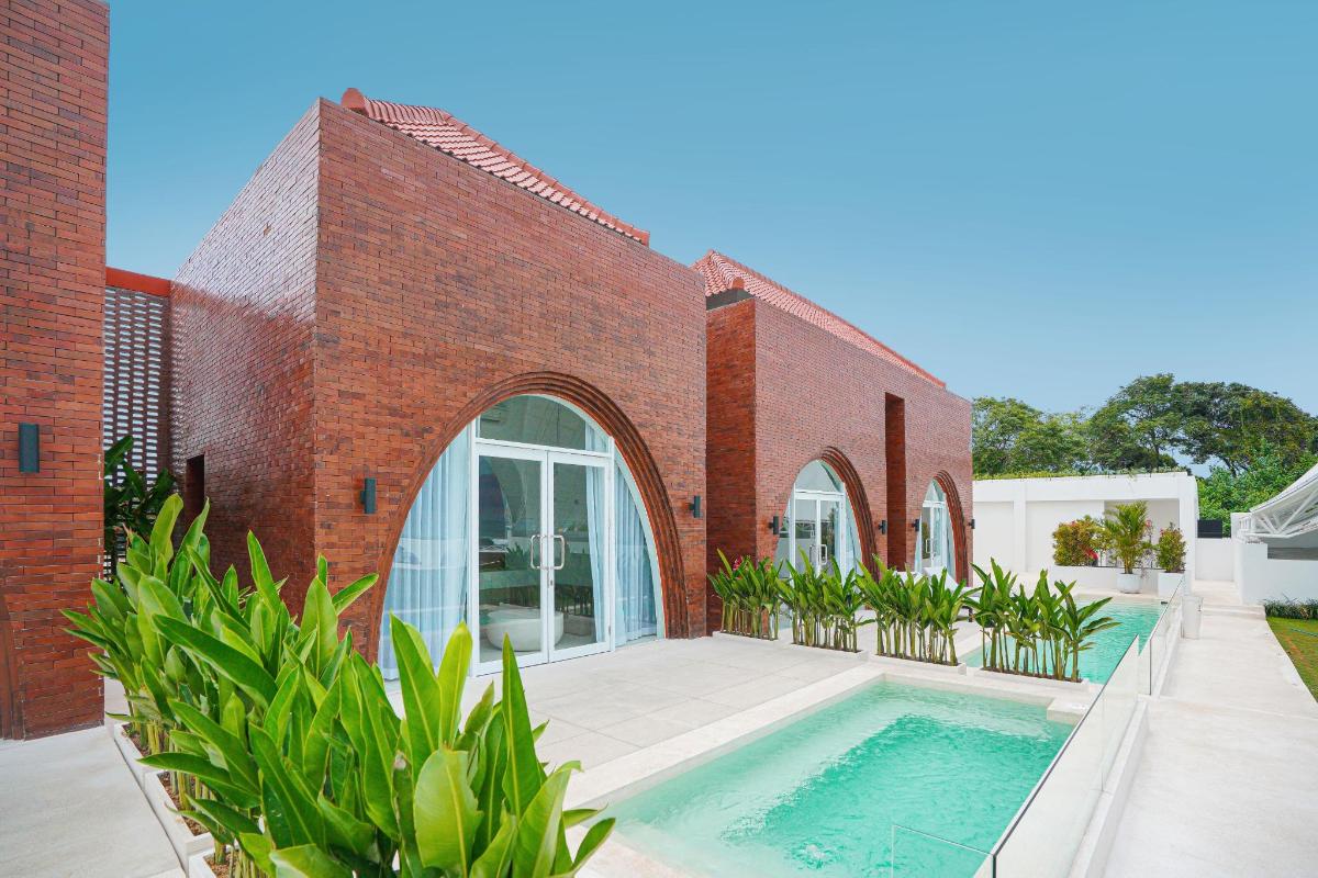 a brick building with a swimming pool in front of it