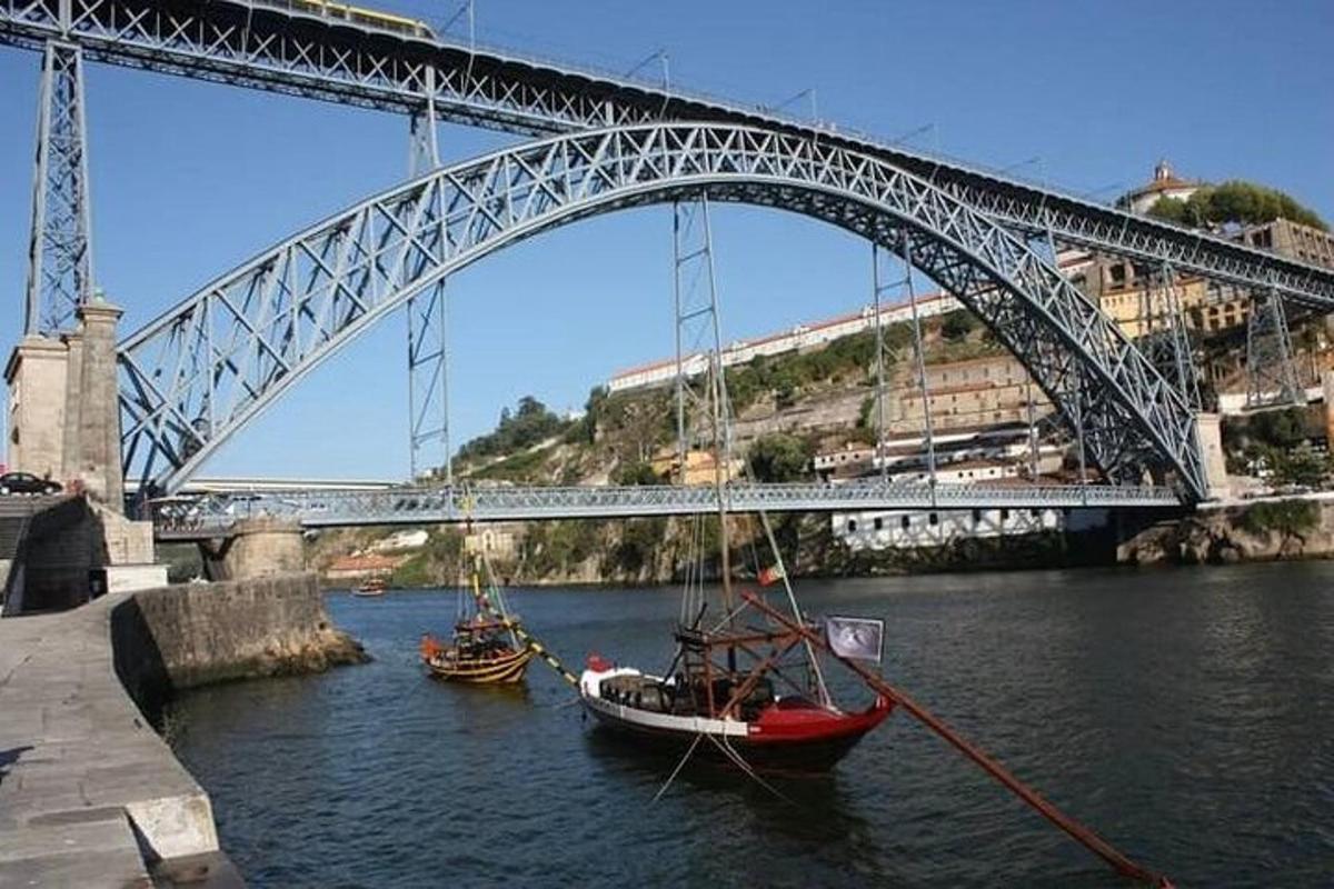 two boats in the water under a bridge
