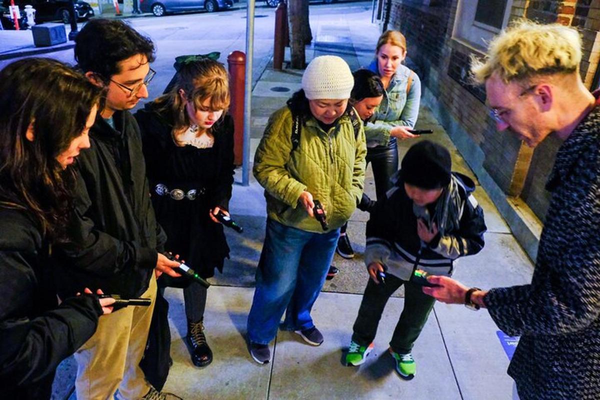 a group of people looking at their cell phones