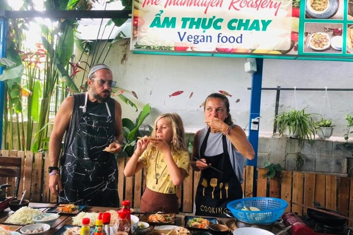 two men and a little girl eating food