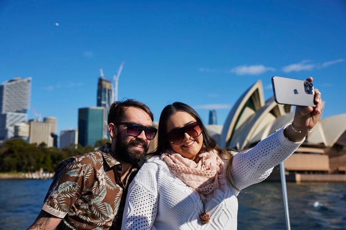a man and a woman taking a picture in front of the opera house