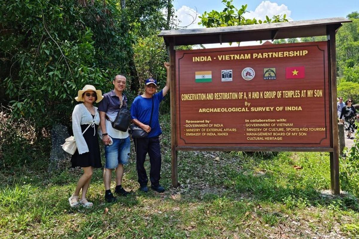 a group of people standing in front of a sign