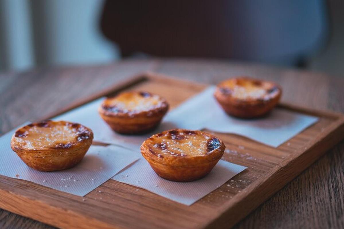 four muffins on a wooden tray on a table