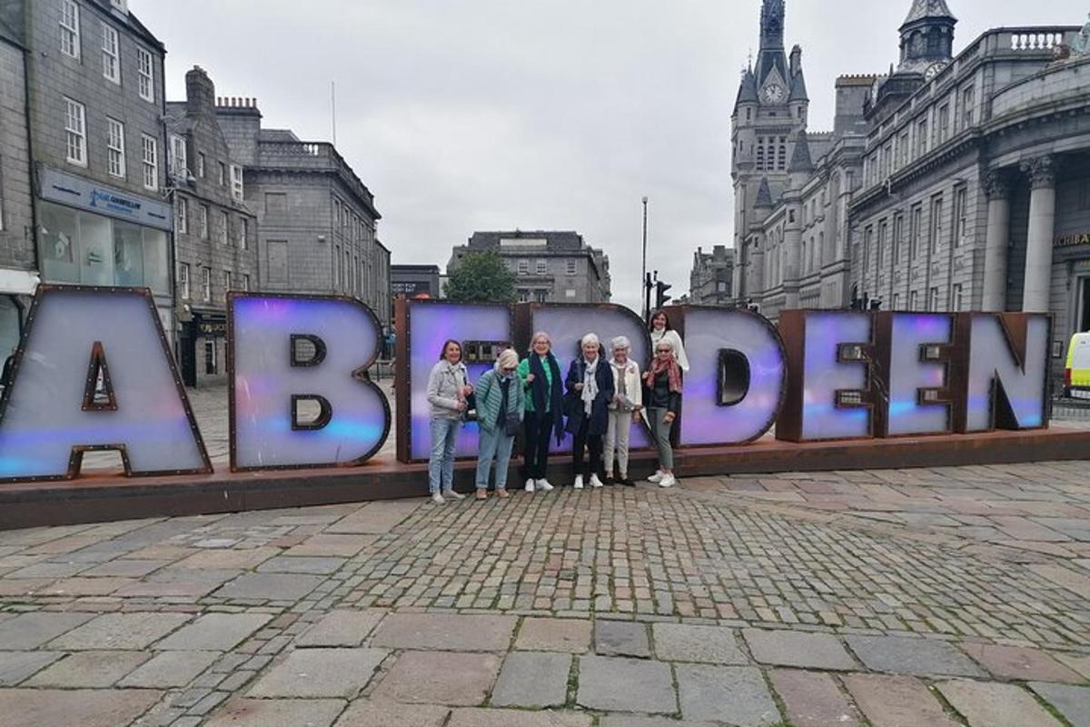 a group of people standing in front of a large sign