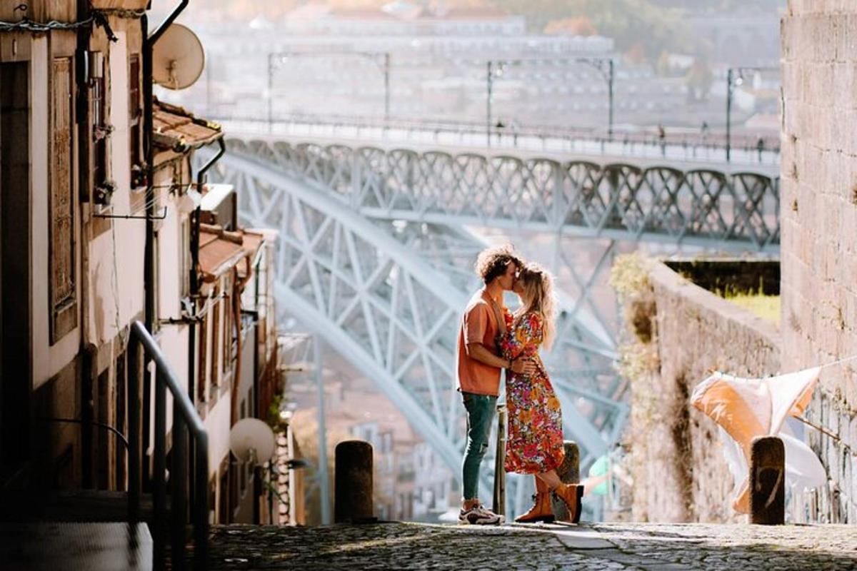 a couple kissing in front of a bridge