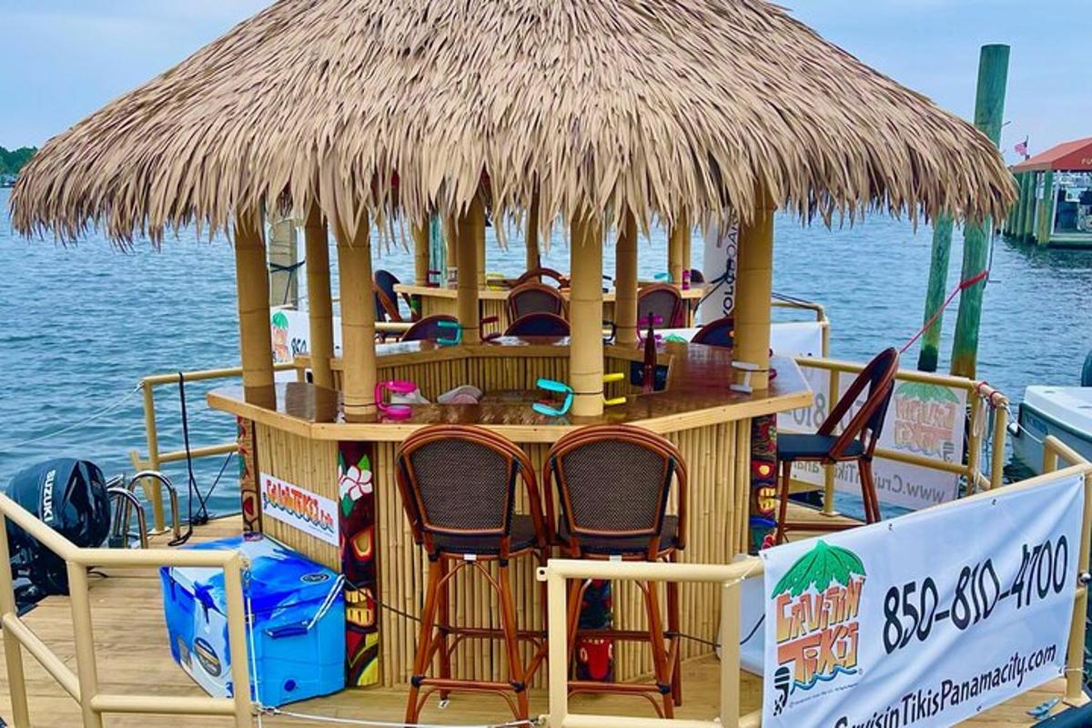 a bar on a boat with chairs and a straw roof