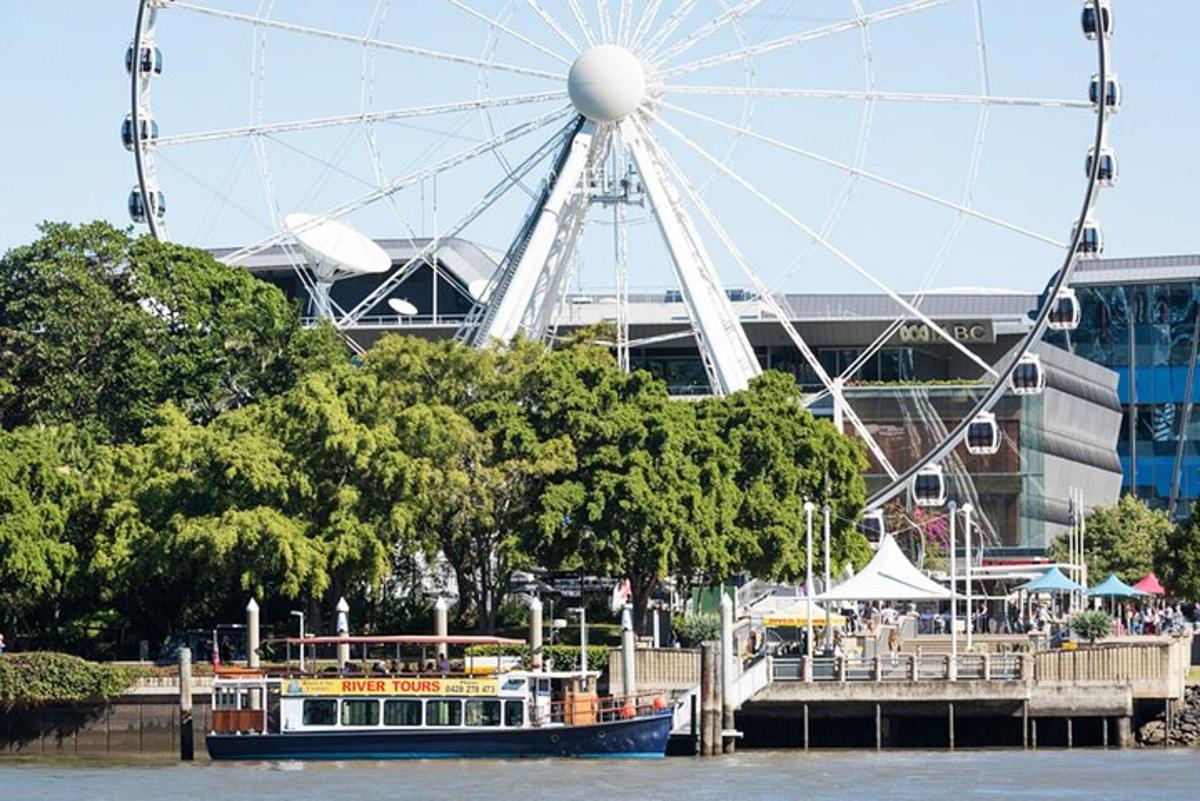 a ferris wheel and a boat on the water