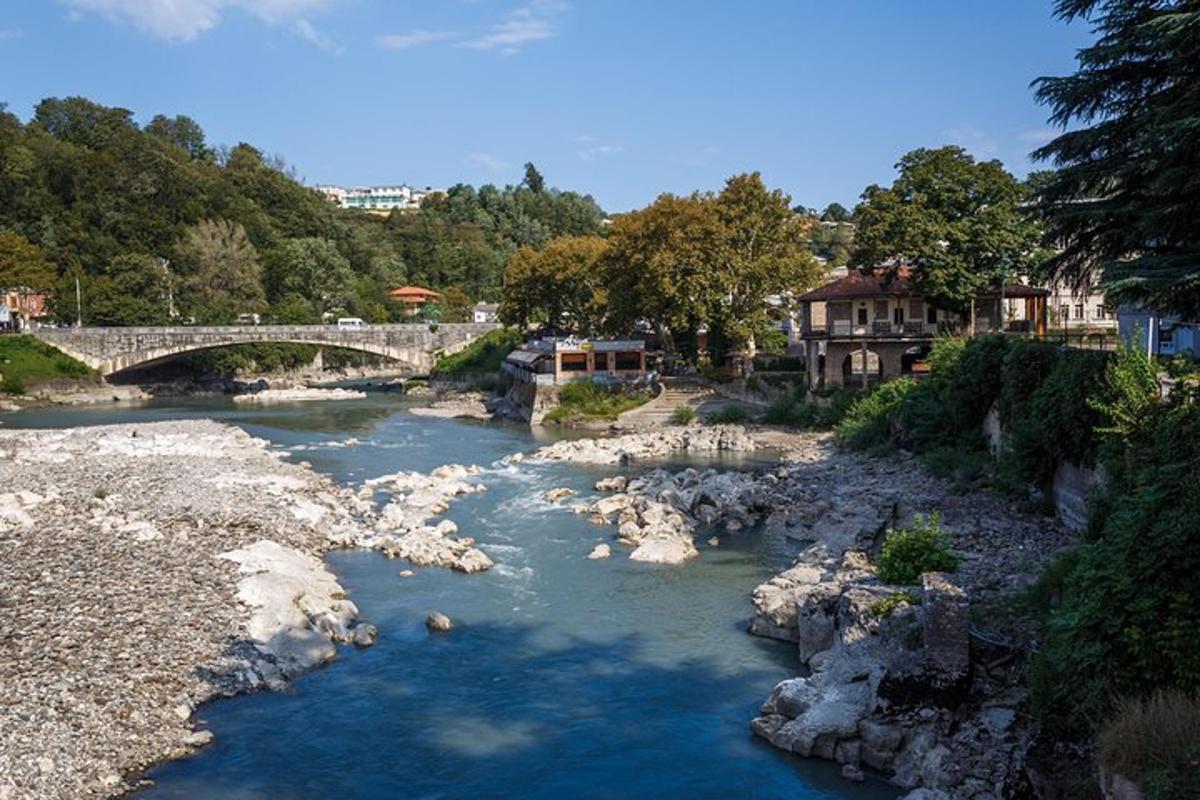 a river with a bridge and some rocks