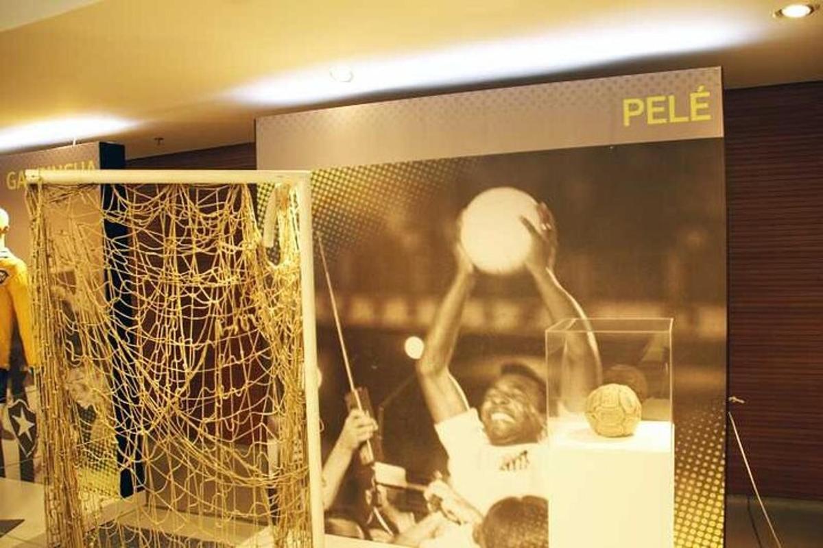 a display case of a man hitting a ball