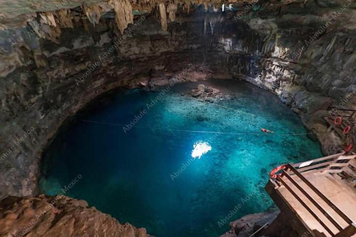 a cave with a pool of blue water