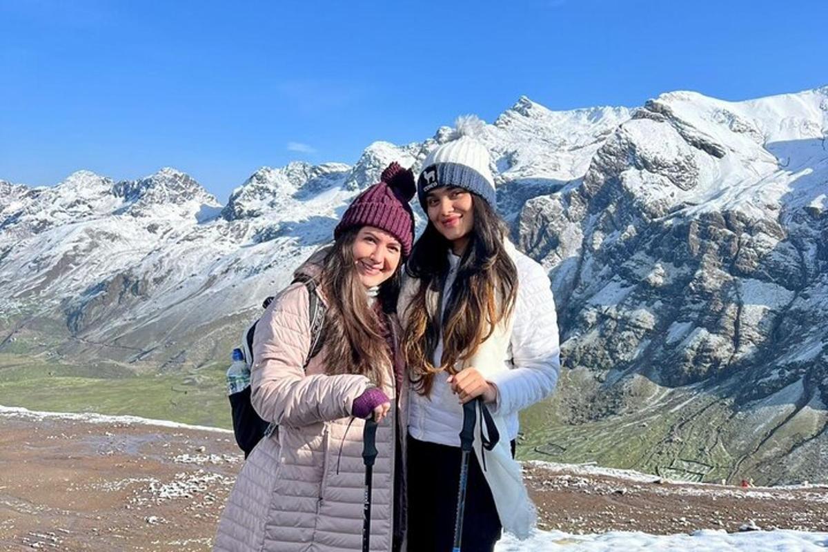 twee vrouwen staan op de top van een berg