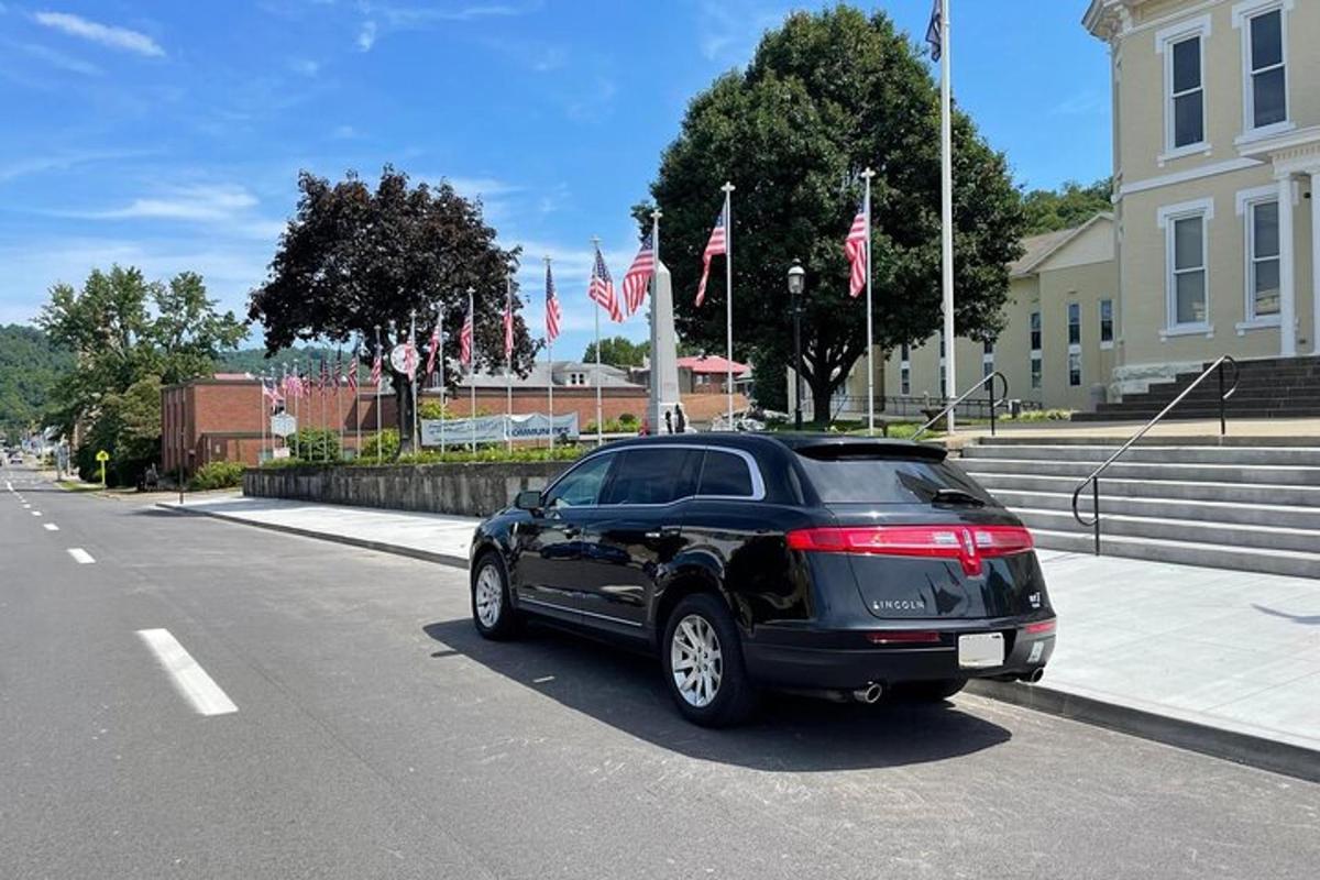 a black car parked on the side of a street