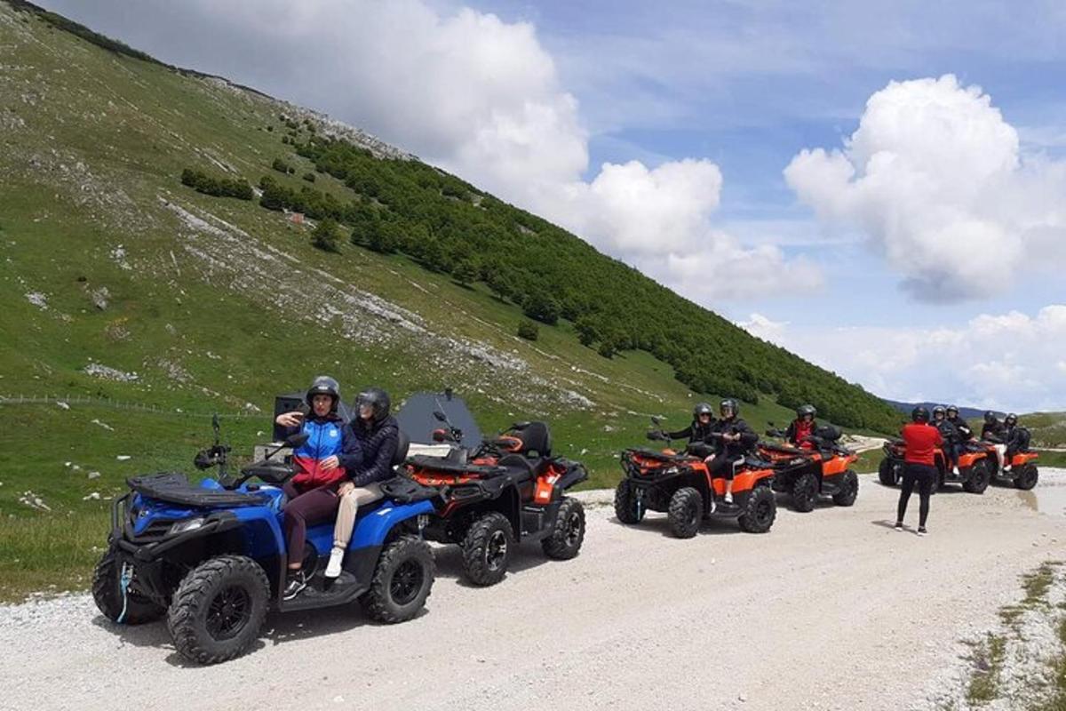 a group of people riding atvs on a dirt road