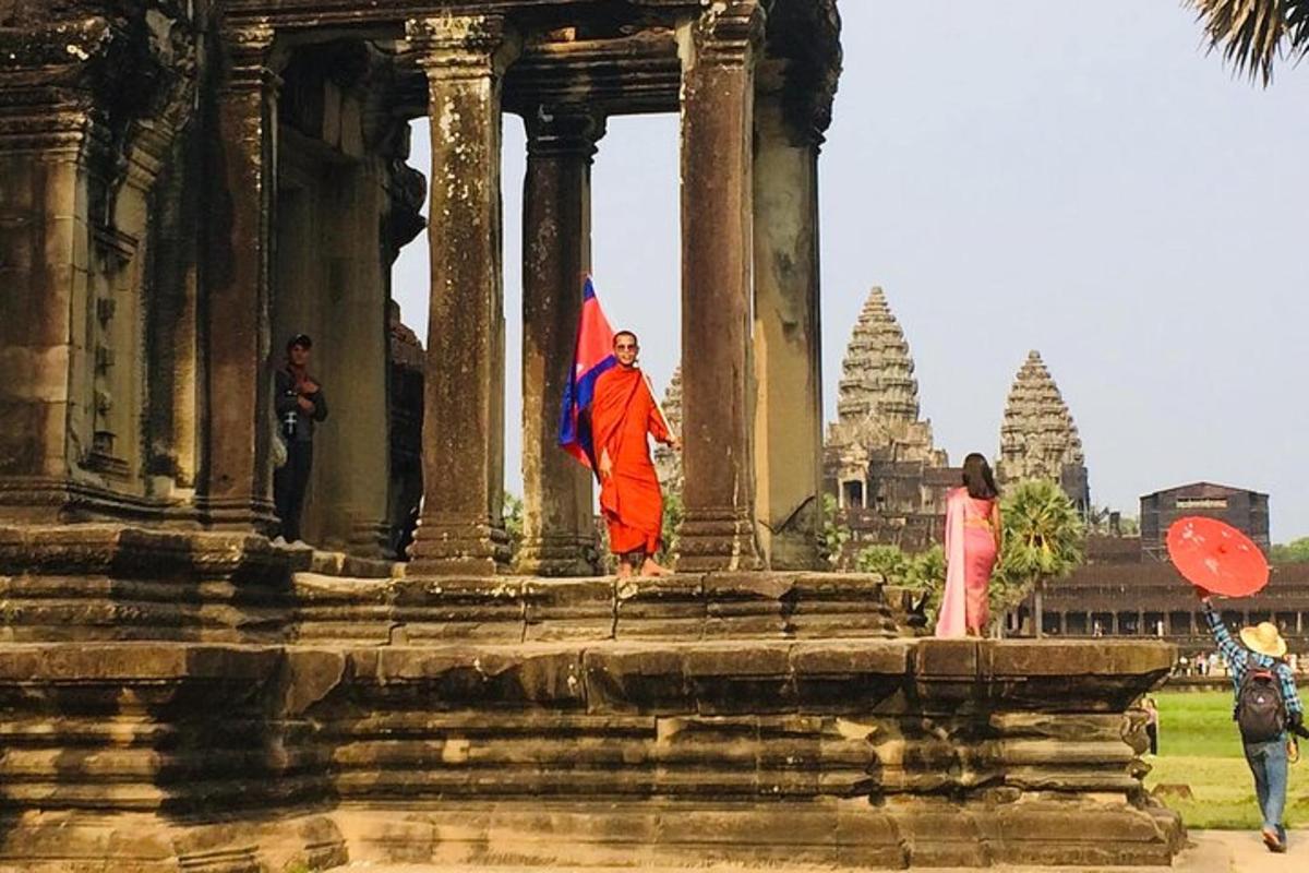 a man holding a flag in front of a temple