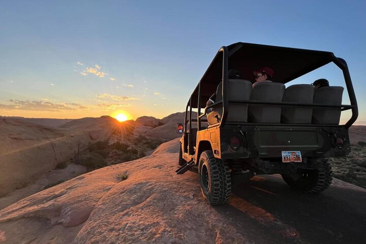a jeep driving down a dirt road in the desert