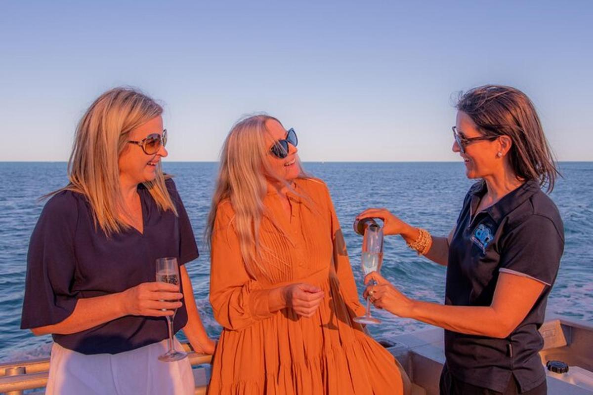 two women standing on a boat in the ocean