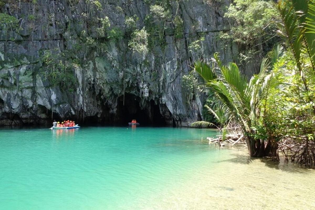 a group of people in a boat in a cave