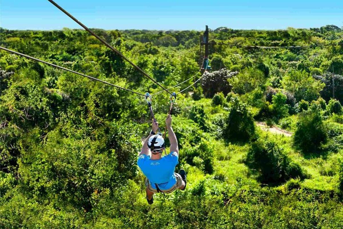 a man is hanging on a zip line