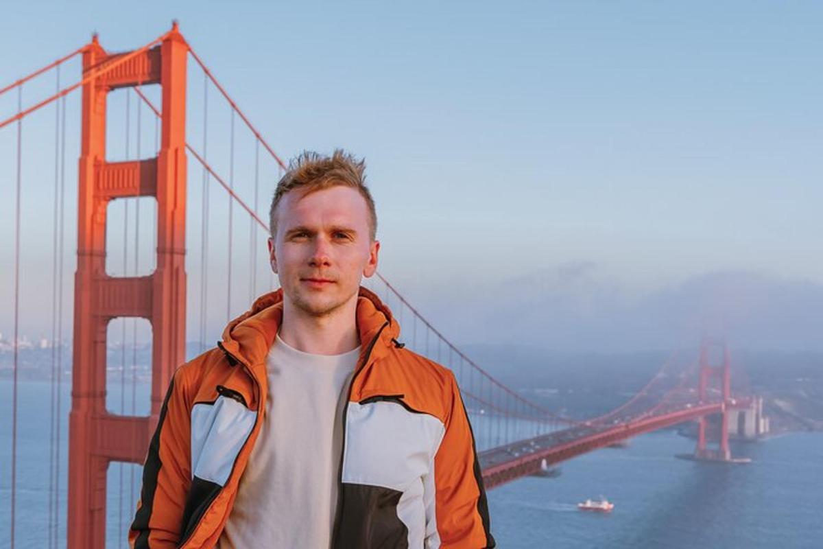 Un hombre parado frente al puente Golden Gate