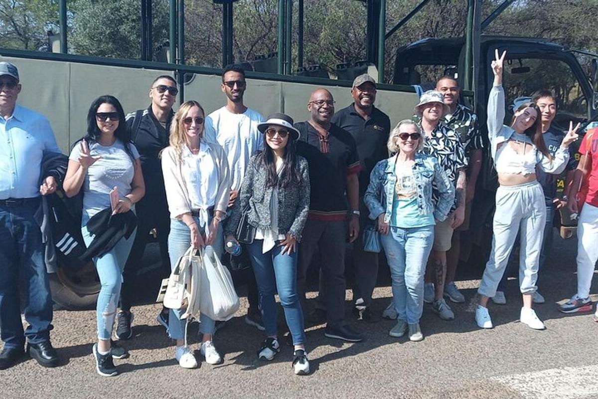 a group of people standing in front of a bus