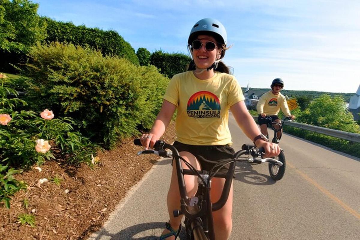 a woman riding a bike down a road